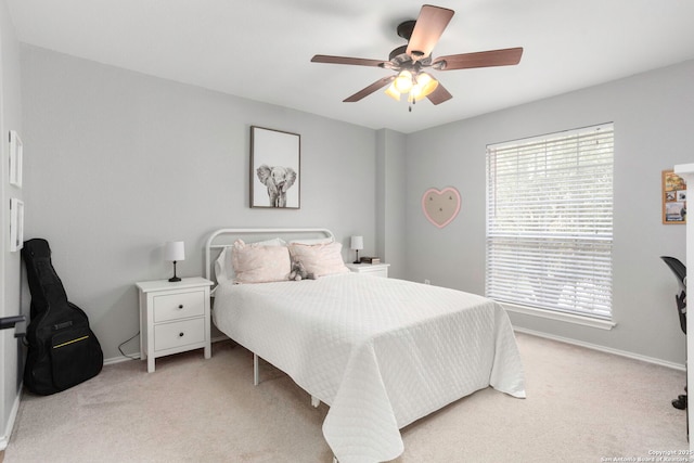 24719 Alamosa Fls, San Antonio, TX 78255 - bedroom with light carpet, multiple windows, baseboards, and ceiling fan