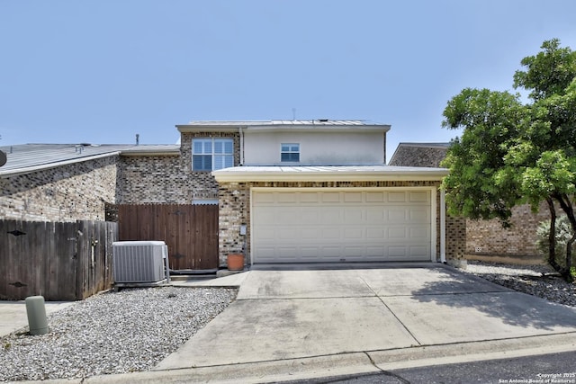 67 Oakwell Farms, San Antonio, TX 78218 - view of front of house with brick siding, cooling unit, driveway, and a garage