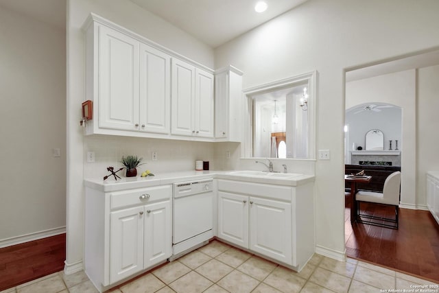 67 Oakwell Farms, San Antonio, TX 78218 - kitchen featuring white dishwasher, a sink, white cabinets, and tile countertops