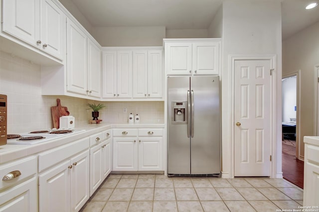 67 Oakwell Farms, San Antonio, TX 78218 - kitchen with stainless steel fridge with ice dispenser, tile countertops, white cabinetry, and decorative backsplash