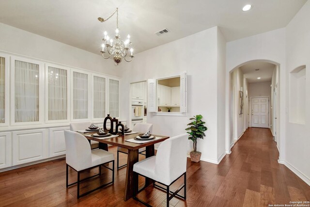 67 Oakwell Farms, San Antonio, TX 78218 - dining room featuring arched walkways, dark wood-type flooring, a chandelier, baseboards, and recessed lighting