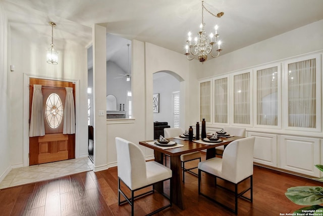 67 Oakwell Farms, San Antonio, TX 78218 - dining space with arched walkways, hardwood / wood-style floors, baseboards, a chandelier, and vaulted ceiling