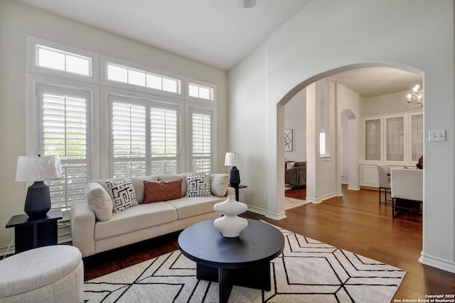 67 Oakwell Farms, San Antonio, TX 78218 - living room with arched walkways, plenty of natural light, wood finished floors, a chandelier, and a towering ceiling