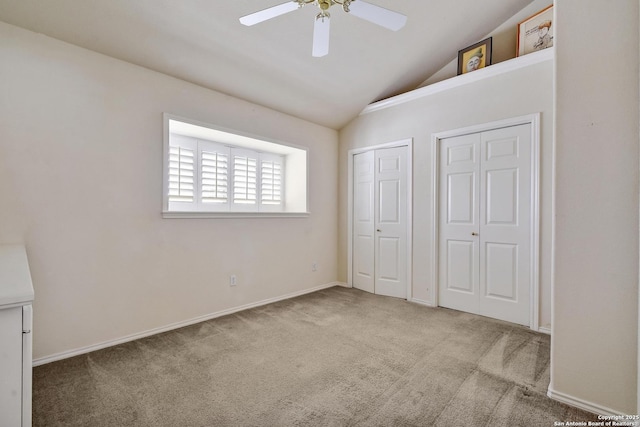 67 Oakwell Farms, San Antonio, TX 78218 - unfurnished bedroom featuring two closets, carpet floors, vaulted ceiling, a ceiling fan, and baseboards