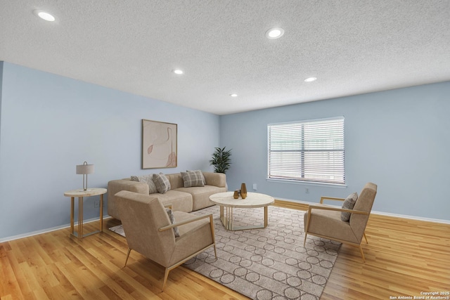 11202 Candle Park, San Antonio, TX 78249 - living area featuring a textured ceiling, wood finished floors, recessed lighting, and baseboards