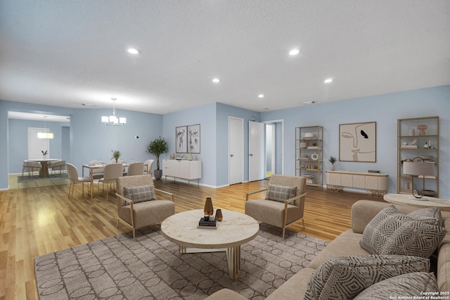 11202 Candle Park, San Antonio, TX 78249 - living area featuring a chandelier, wood finished floors, recessed lighting, baseboards, and a textured ceiling