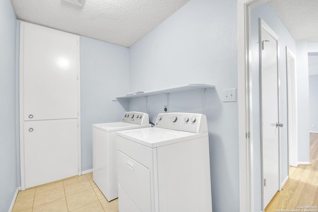 11202 Candle Park, San Antonio, TX 78249 - washroom with a textured ceiling, independent washer and dryer, baseboards, and light tile patterned floors