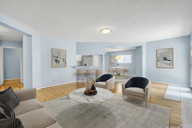 11202 Candle Park, San Antonio, TX 78249 - living area featuring wood finished floors, baseboards, and a textured ceiling