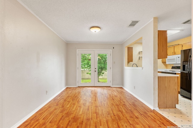 6826 Evercrest, San Antonio, TX 78239 - unfurnished living room featuring light wood-type flooring, a textured ceiling, ornamental molding, and baseboards
