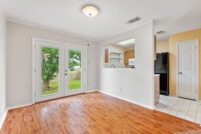 6826 Evercrest, San Antonio, TX 78239 - spare room with french doors, light wood finished floors, baseboards, a textured ceiling, and crown molding