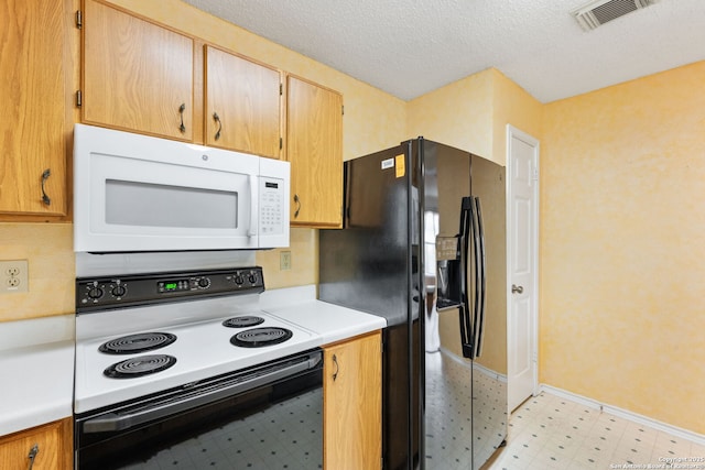 6826 Evercrest, San Antonio, TX 78239 - kitchen with range with electric cooktop, white microwave, light flooring, black fridge with ice dispenser, and light countertops