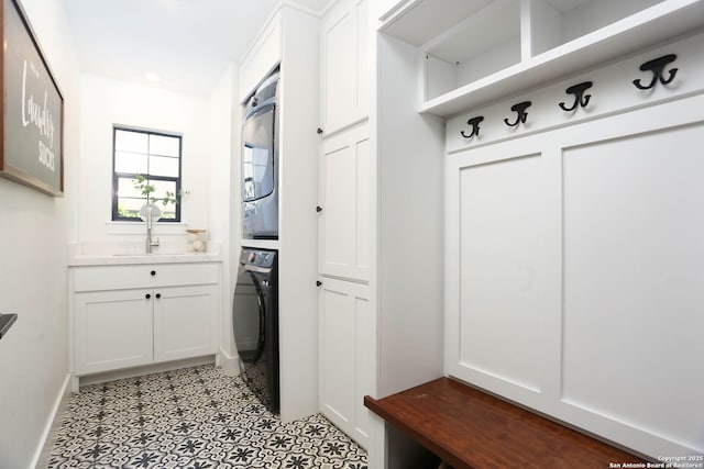 8306 Country Side, San Antonio, TX 78209 - mudroom featuring estacked washer and dryer, a sink, and baseboards