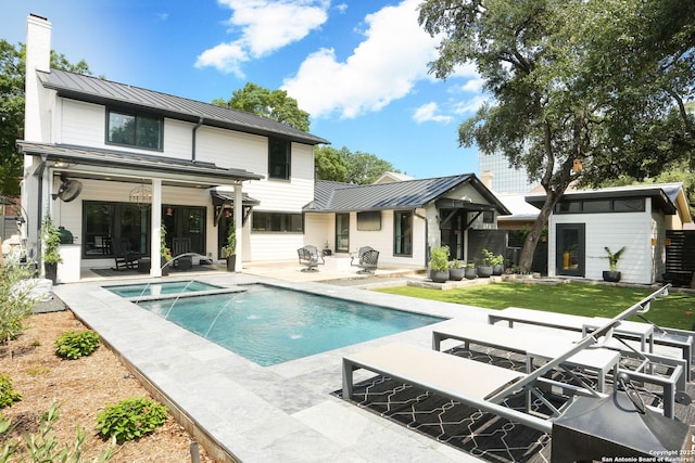 8306 Country Side, San Antonio, TX 78209 - back of property featuring a standing seam roof, metal roof, a patio, and a pool with connected hot tub