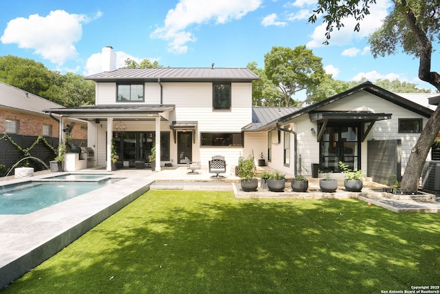 8306 Country Side, San Antonio, TX 78209 - back of property with a standing seam roof, metal roof, a patio area, a chimney, and a pool with connected hot tub
