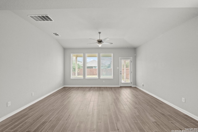 12942 Irvin Path, San Antonio, TX 78254 - spare room featuring wood finished floors, healthy amount of natural light, a ceiling fan, and baseboards