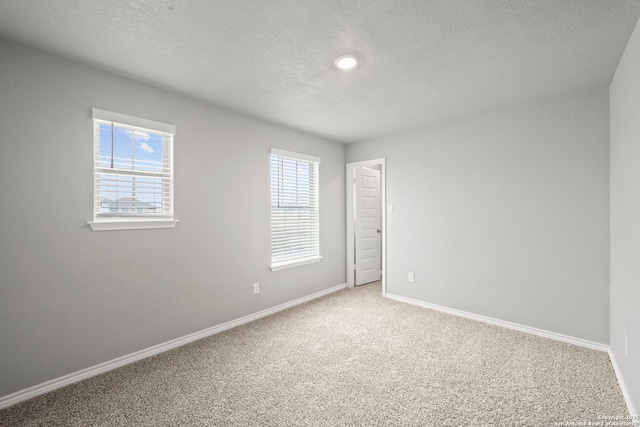 12942 Irvin Path, San Antonio, TX 78254 - unfurnished bedroom featuring light colored carpet, a textured ceiling, and baseboards