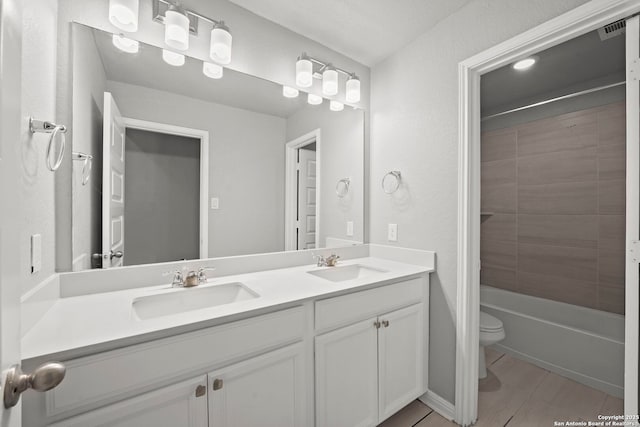 12942 Irvin Path, San Antonio, TX 78254 - bathroom with double vanity, toilet, tile patterned floors, and shower / washtub combination