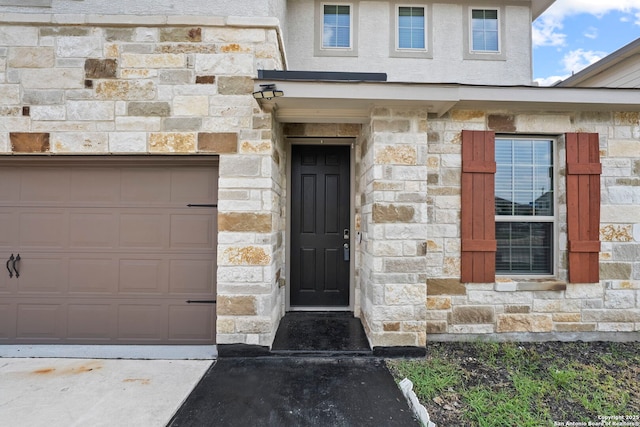 12942 Irvin Path, San Antonio, TX 78254 - view of exterior entry featuring stone siding and a garage