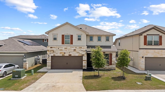 12942 Irvin Path, San Antonio, TX 78254 - view of front facade featuring stone siding, concrete driveway, an attached garage, stucco siding, and a front yard