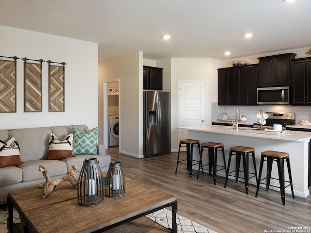 204 Dakota Rdg, Cibolo, TX 78108 - living area featuring washer / clothes dryer, light wood-type flooring, recessed lighting, and baseboards