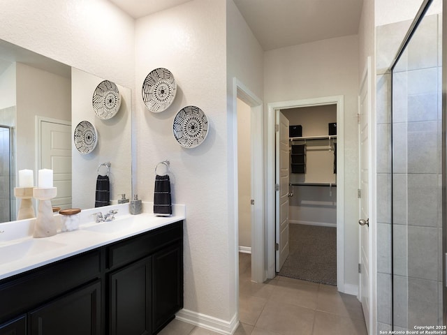 204 Dakota Rdg, Cibolo, TX 78108 - bathroom with a spacious closet, a stall shower, double vanity, tile patterned flooring, and baseboards