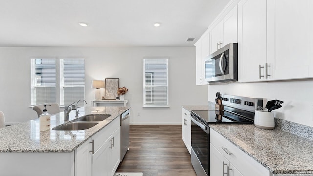 729 Heartseed Ave, New Braunfels, TX 78130 - kitchen featuring stainless steel appliances, a sink, a center island with sink, dark wood-style floors, and baseboards