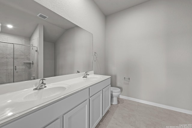 6228 Persimmon Lk, San Antonio, TX 78254 - bathroom featuring double vanity, toilet, a tile shower, baseboards, and tile patterned flooring