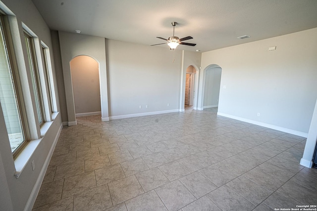 5721 Provo Pl, San Antonio, TX 78263 - unfurnished room with arched walkways, a ceiling fan, and baseboards