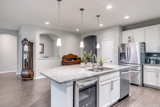 7604 Pecos Rdg, Boerne, TX 78015 - kitchen featuring stainless steel refrigerator with ice dispenser, wine cooler, arched walkways, a sink, and recessed lighting