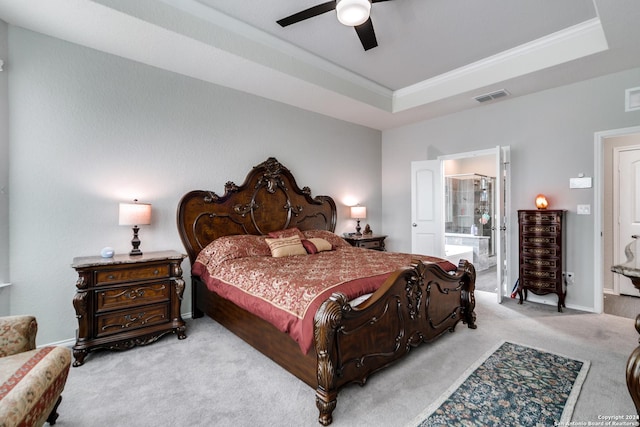 7604 Pecos Rdg, Boerne, TX 78015 - bedroom with light carpet, ornamental molding, a raised ceiling, a ceiling fan, and connected bathroom