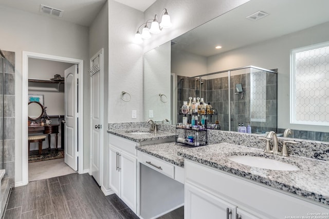 7604 Pecos Rdg, Boerne, TX 78015 - full bath with double vanity, a stall shower, and wood finished floors