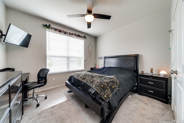 7604 Pecos Rdg, Boerne, TX 78015 - bedroom with light carpet, a desk, baseboards, and a ceiling fan
