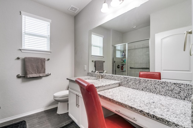 7604 Pecos Rdg, Boerne, TX 78015 - full bath featuring vanity, toilet, a stall shower, wood finished floors, and baseboards