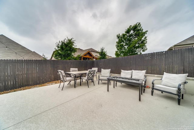 7604 Pecos Rdg, Boerne, TX 78015 - fenced backyard with a patio area, outdoor dining space, and an outdoor hangout area