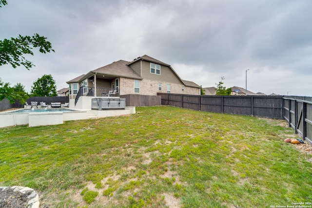 7604 Pecos Rdg, Boerne, TX 78015 - rear view of house with brick siding and a hot tub