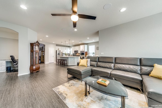 7604 Pecos Rdg, Boerne, TX 78015 - living room featuring arched walkways, a desk, a ceiling fan, recessed lighting, and wood finished floors