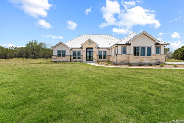 3828 Palomino Spgs, Bandera, TX 78003 - view of front of property featuring french doors, stone siding, a standing seam roof, and a front lawn