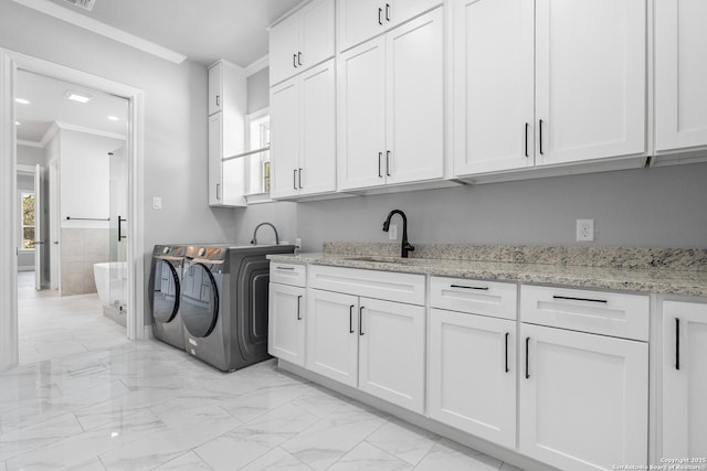 3828 Palomino Spgs, Bandera, TX 78003 - laundry room featuring cabinet space, separate washer and dryer, crown molding, and light marble finish flooring
