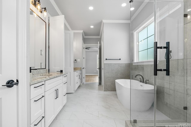 3828 Palomino Spgs, Bandera, TX 78003 - full bathroom featuring crown molding, vanity, a freestanding tub, marble look tile flooring, and recessed lighting