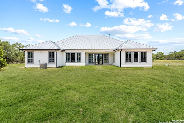 3828 Palomino Spgs, Bandera, TX 78003 - back of house with a standing seam roof, stucco siding, a yard, metal roof, and french doors