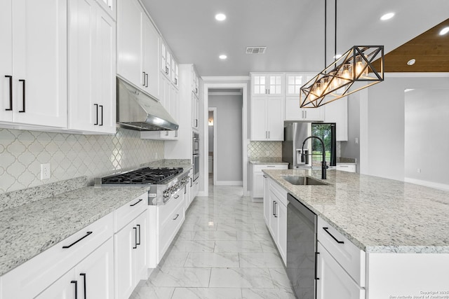3828 Palomino Spgs, Bandera, TX 78003 - kitchen with appliances with stainless steel finishes, under cabinet range hood, recessed lighting, light marble finish flooring, and a sink