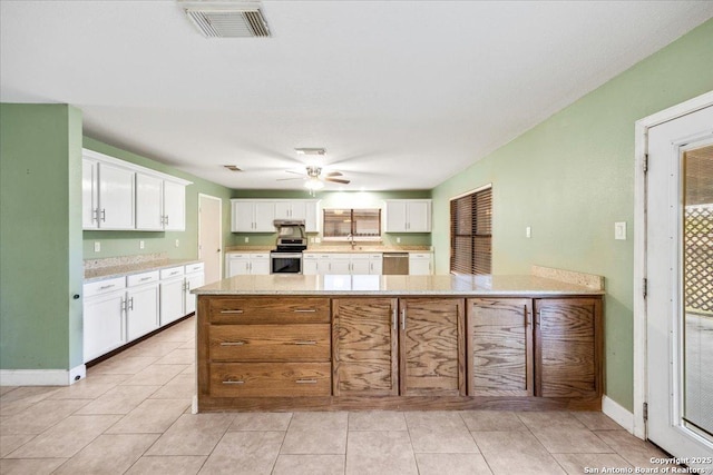 6119 Ferrysage, San Antonio, TX 78244 - kitchen featuring appliances with stainless steel finishes, a sink, white cabinetry, ceiling fan, and a peninsula