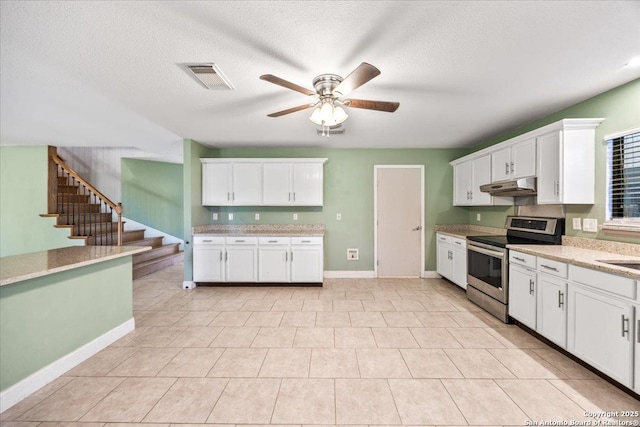 6119 Ferrysage, San Antonio, TX 78244 - kitchen with stainless steel range with electric cooktop, under cabinet range hood, ceiling fan, white cabinetry, and a textured ceiling