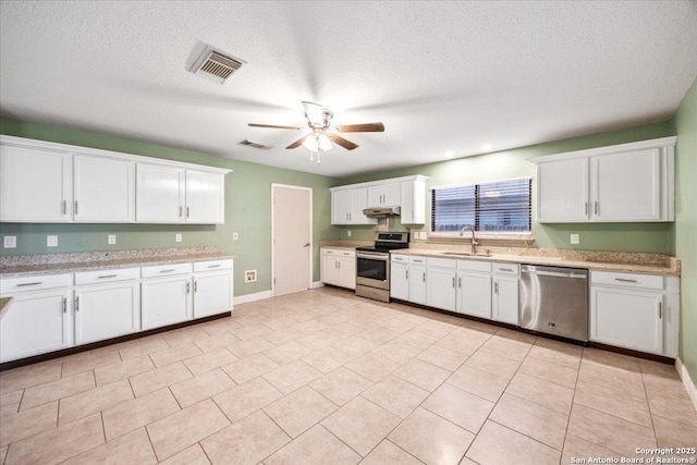 6119 Ferrysage, San Antonio, TX 78244 - kitchen with stainless steel appliances, a sink, under cabinet range hood, ceiling fan, and white cabinets