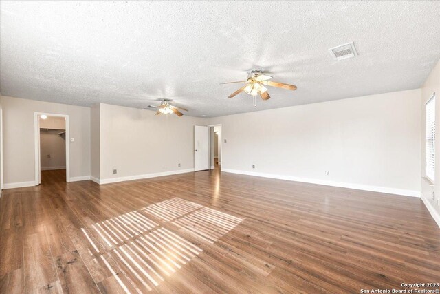 6119 Ferrysage, San Antonio, TX 78244 - unfurnished living room with a ceiling fan, wood finished floors, a textured ceiling, and baseboards