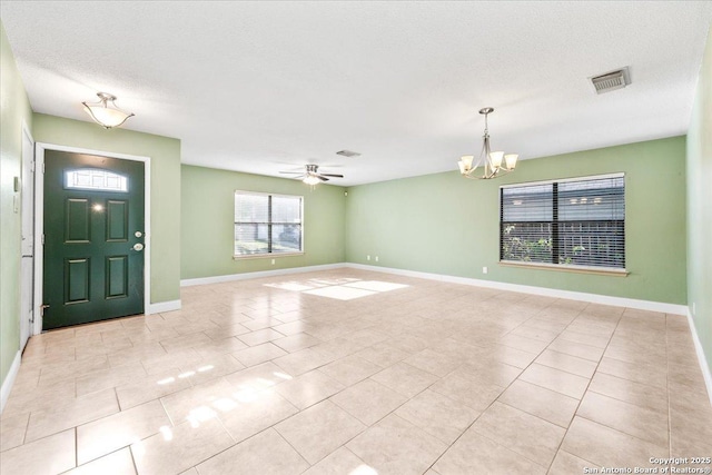 6119 Ferrysage, San Antonio, TX 78244 - foyer entrance with a chandelier, light tile patterned floors, a ceiling fan, baseboards, and a textured ceiling