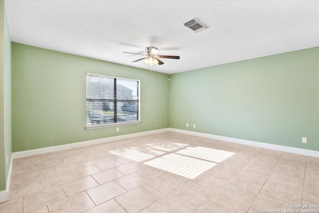 6119 Ferrysage, San Antonio, TX 78244 - empty room with ceiling fan, light tile patterned floors, a textured ceiling, and baseboards