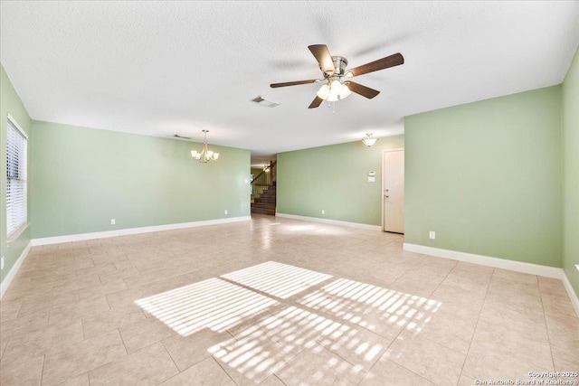 6119 Ferrysage, San Antonio, TX 78244 - spare room featuring stairs, a chandelier, light tile patterned floors, a ceiling fan, and a textured ceiling