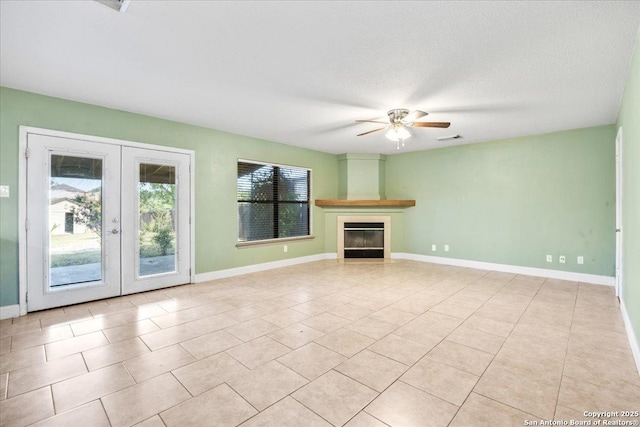 6119 Ferrysage, San Antonio, TX 78244 - unfurnished living room with ceiling fan, french doors, a glass covered fireplace, baseboards, and light tile patterned floors