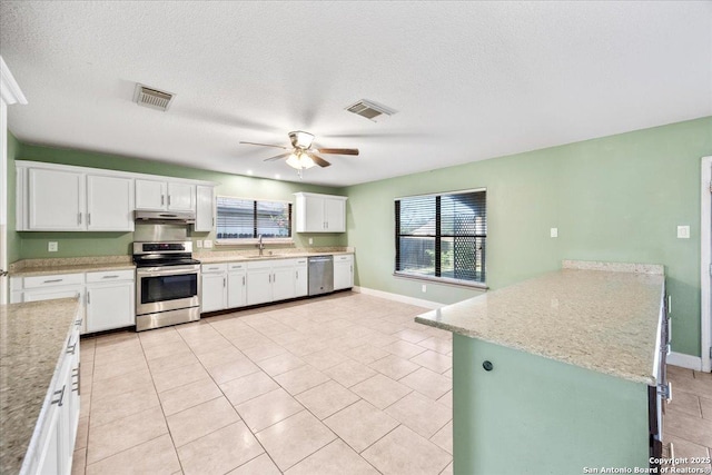 6119 Ferrysage, San Antonio, TX 78244 - kitchen with stainless steel appliances, under cabinet range hood, ceiling fan, plenty of natural light, and a textured ceiling